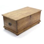 A pine blanket box with hinged lift-lid, wrought iron side handles, & on turned bun feet, 48¾”