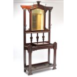 An Edwardian carved mahogany tall standing hall stand, inset rectangular bevelled mirror to top