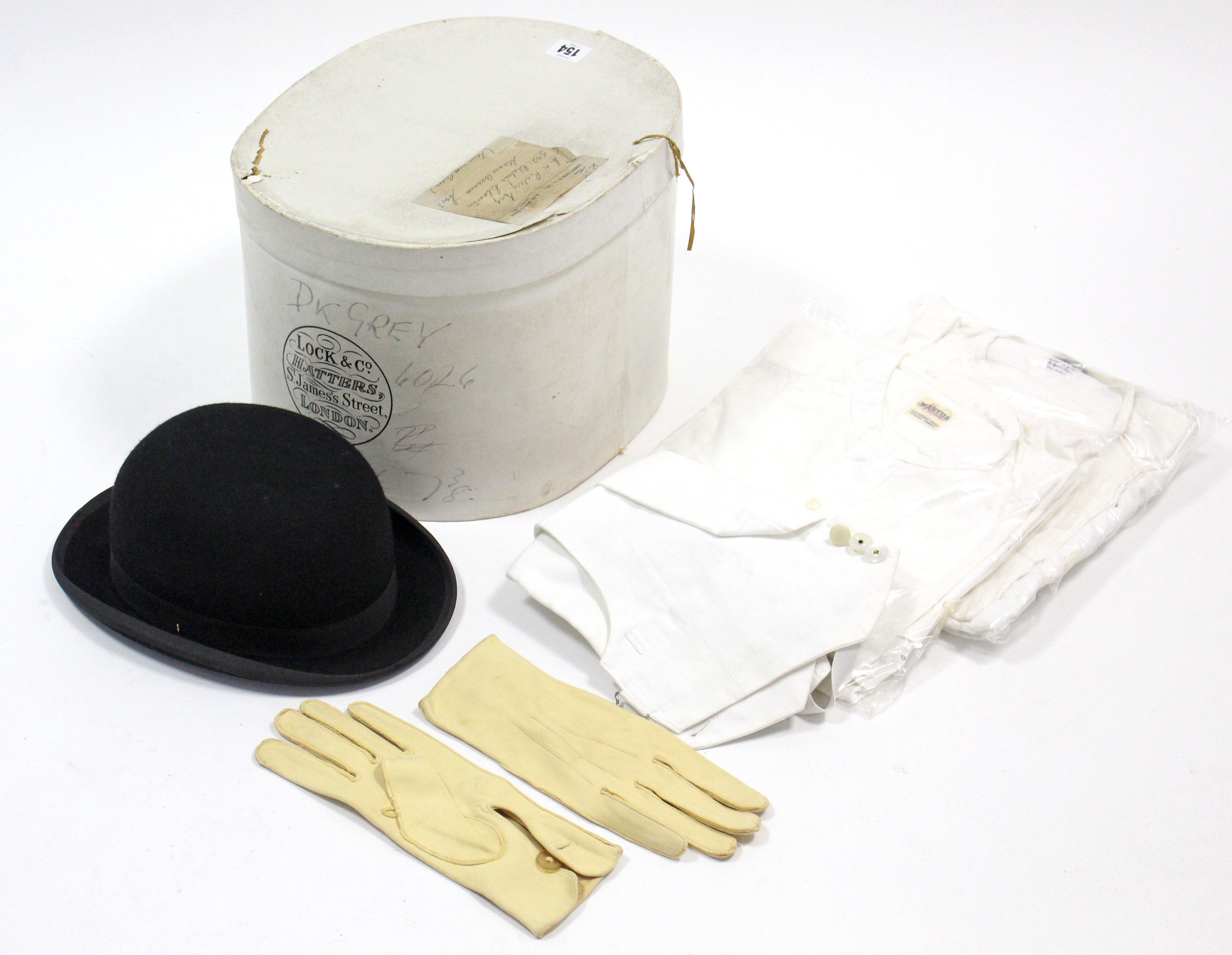 A Lock & Co. London black felt bowler hat with cardboard hatbox; a pair of kid leather gloves; two