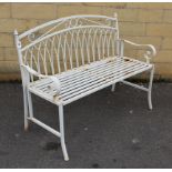 A white painted wrought-metal two-seater garden bench, 42” long.