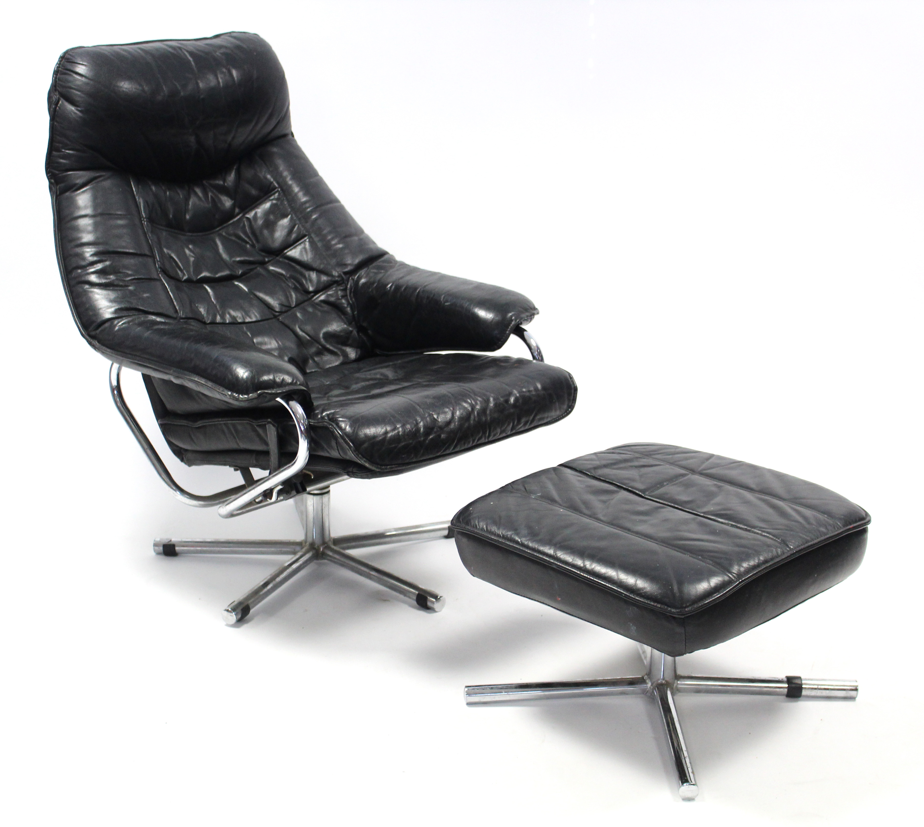 A ‘Skoghaug Industries’ of Norway black leather reclining easy chair & matching footstool, with