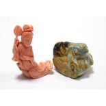 A Chinese carved pink coral reclining female figure holding a fan, 2?” high (fan re-stuck); & a