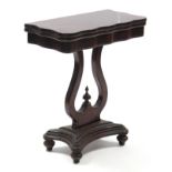 A Victorian mahogany tea table with shaped rectangular fold-over top on lyre support & shaped