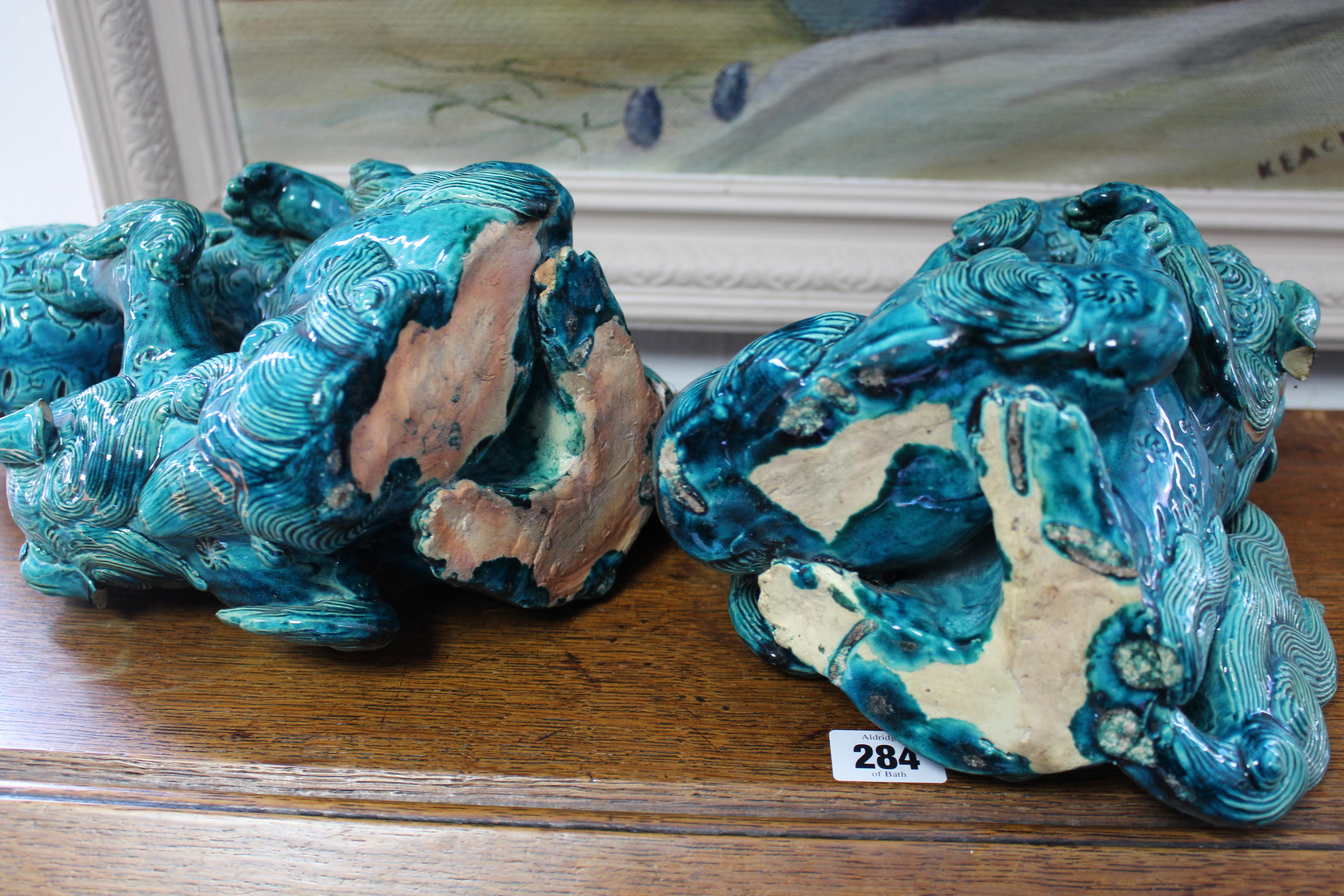 A pair of 19th century Chinese turquoise-glazed groups, each of two Kylin fighting over a brocaded - Image 9 of 9