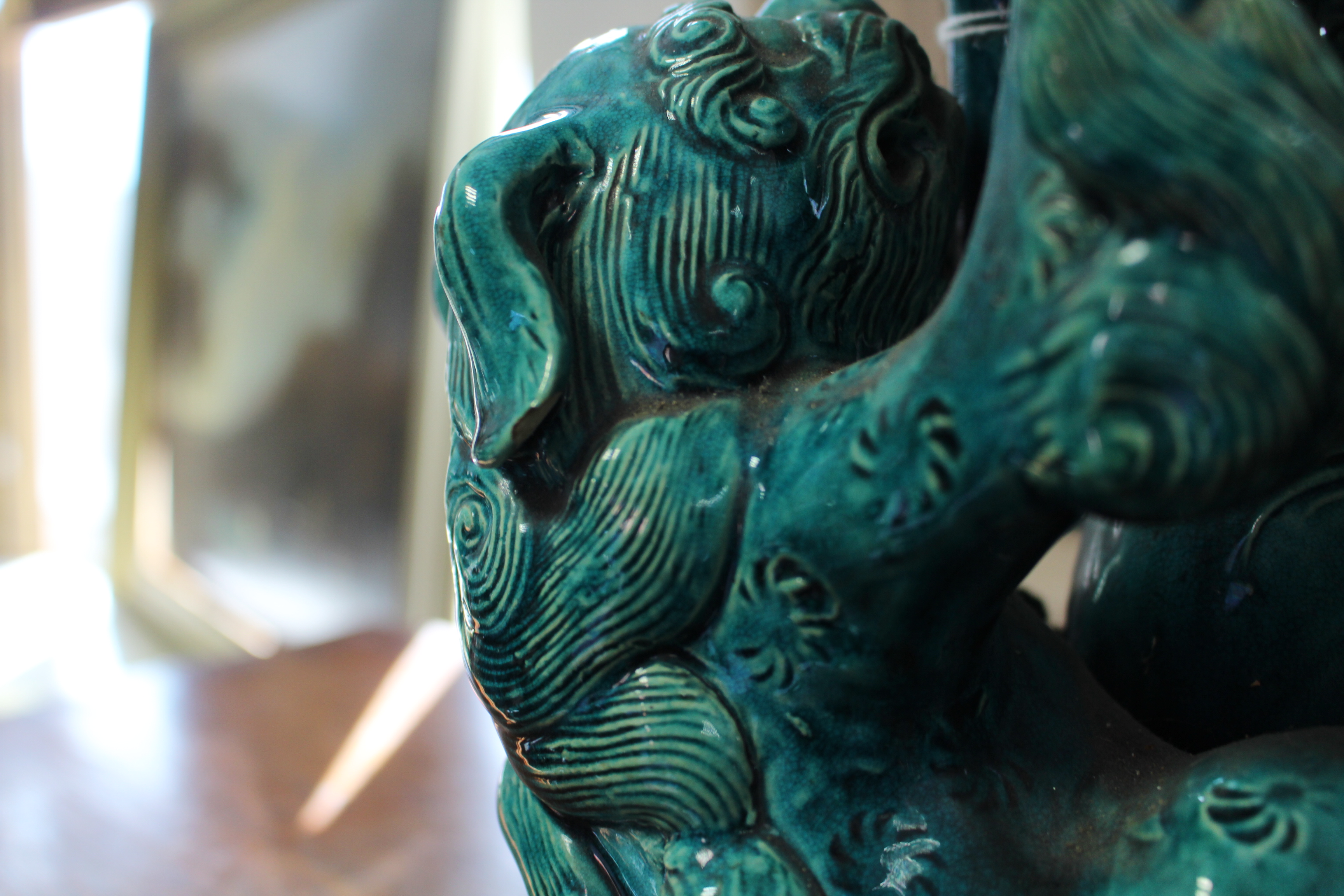 A pair of 19th century Chinese turquoise-glazed groups, each of two Kylin fighting over a brocaded - Image 8 of 9