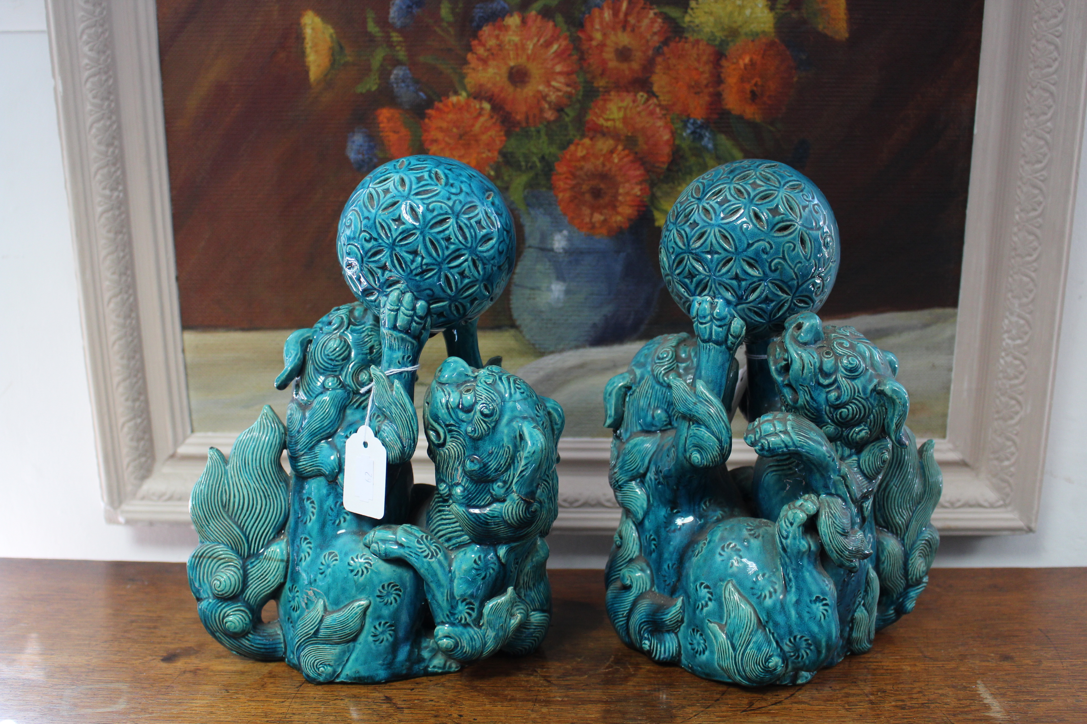 A pair of 19th century Chinese turquoise-glazed groups, each of two Kylin fighting over a brocaded - Image 3 of 9