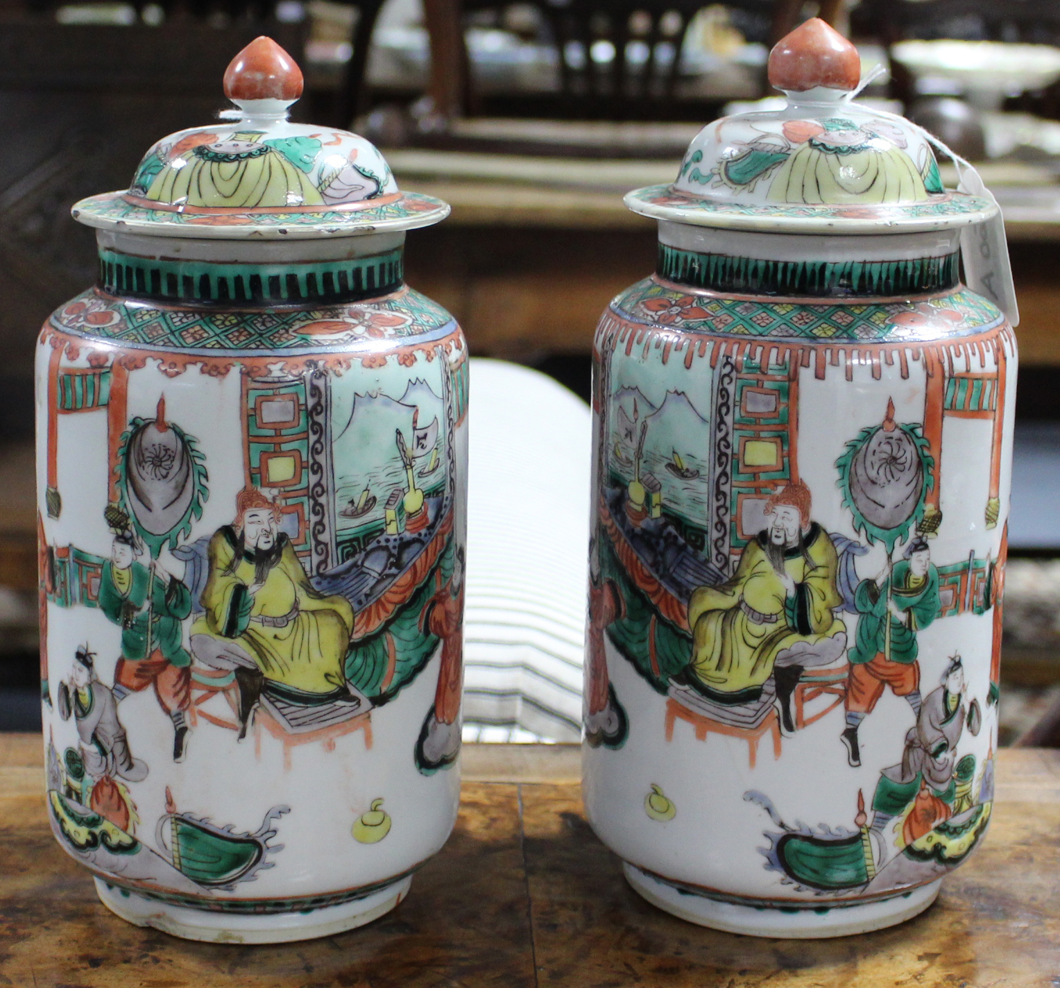 A pair of Chinese porcelain famille verte jars & covers, decorated with courtly figure scenes in the