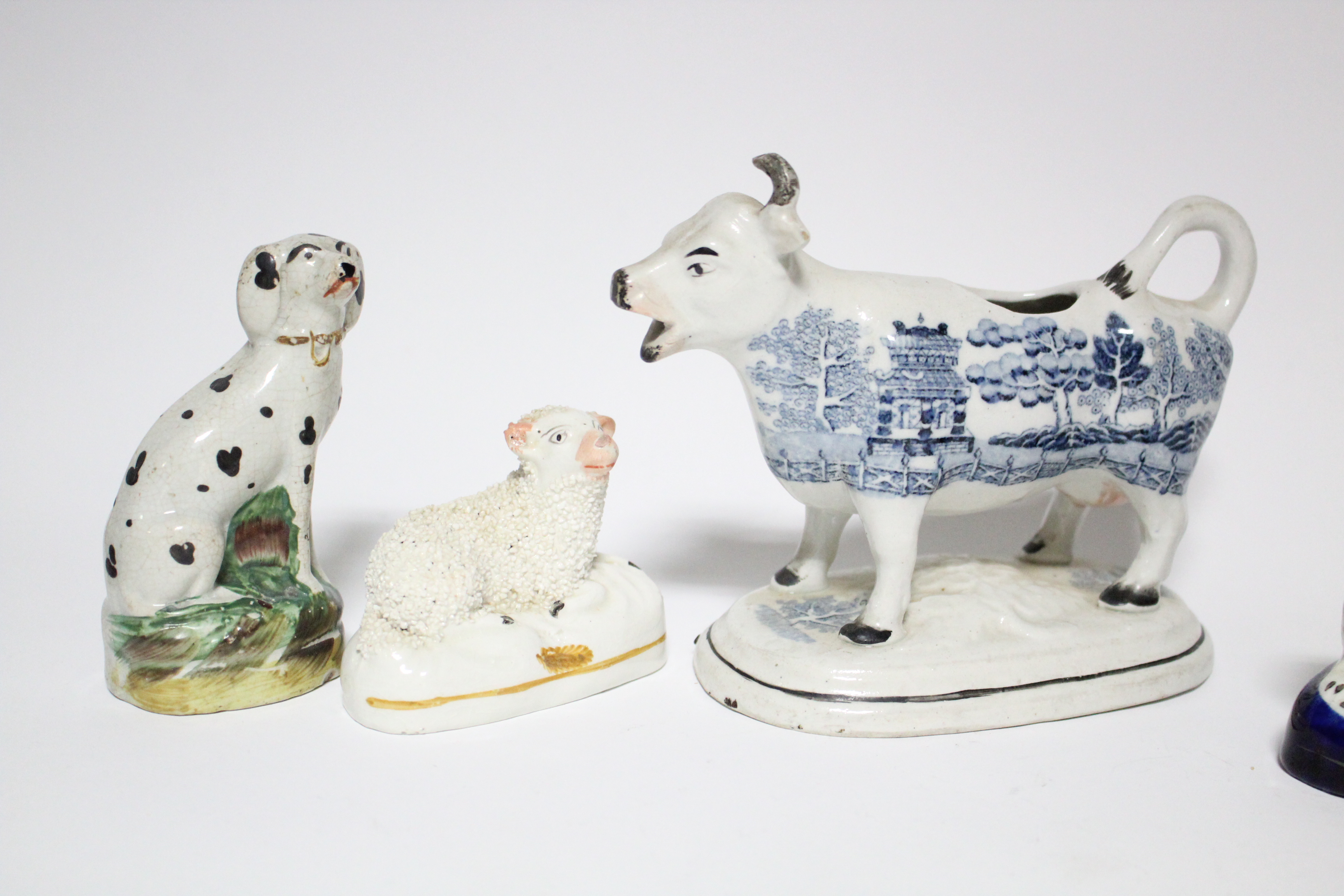 Three small Victorian Staffordshire pottery models of seated dogs, the largest 4” high; a ditto - Image 2 of 5