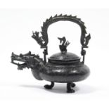 A late 19th century Chinese bronze teapot with squat round body, dragon spout & swing handle in