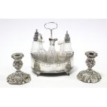 A George III silver oval cruet stand with centre ring handle, straight pierced sides, on four