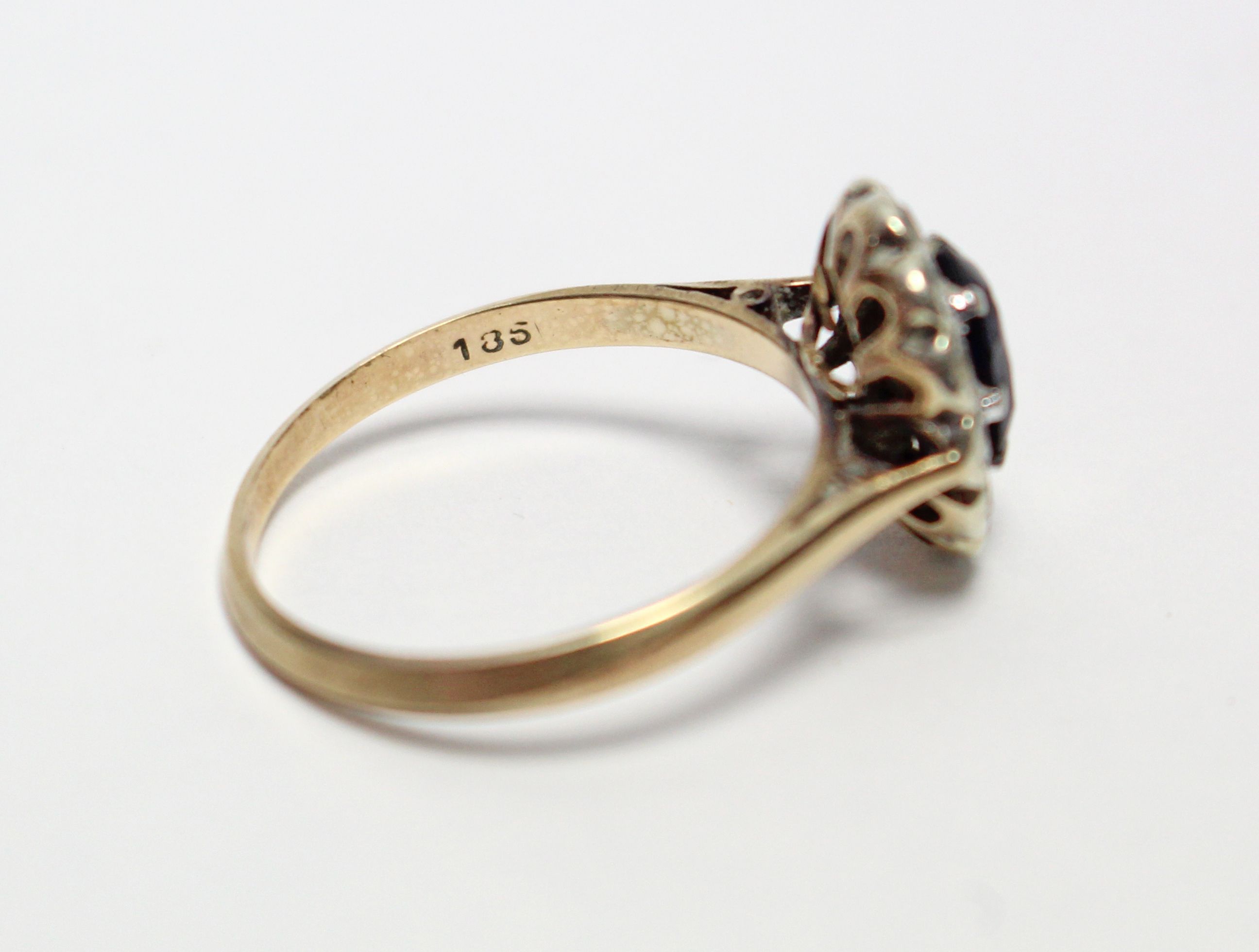 A 9ct. gold ring set oval synthetic sapphire within a border of small diamonds. - Image 4 of 5