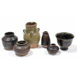 Four early Chinese brown-glazed small pottery vessels, the largest 4½” high; a ditto bowl with