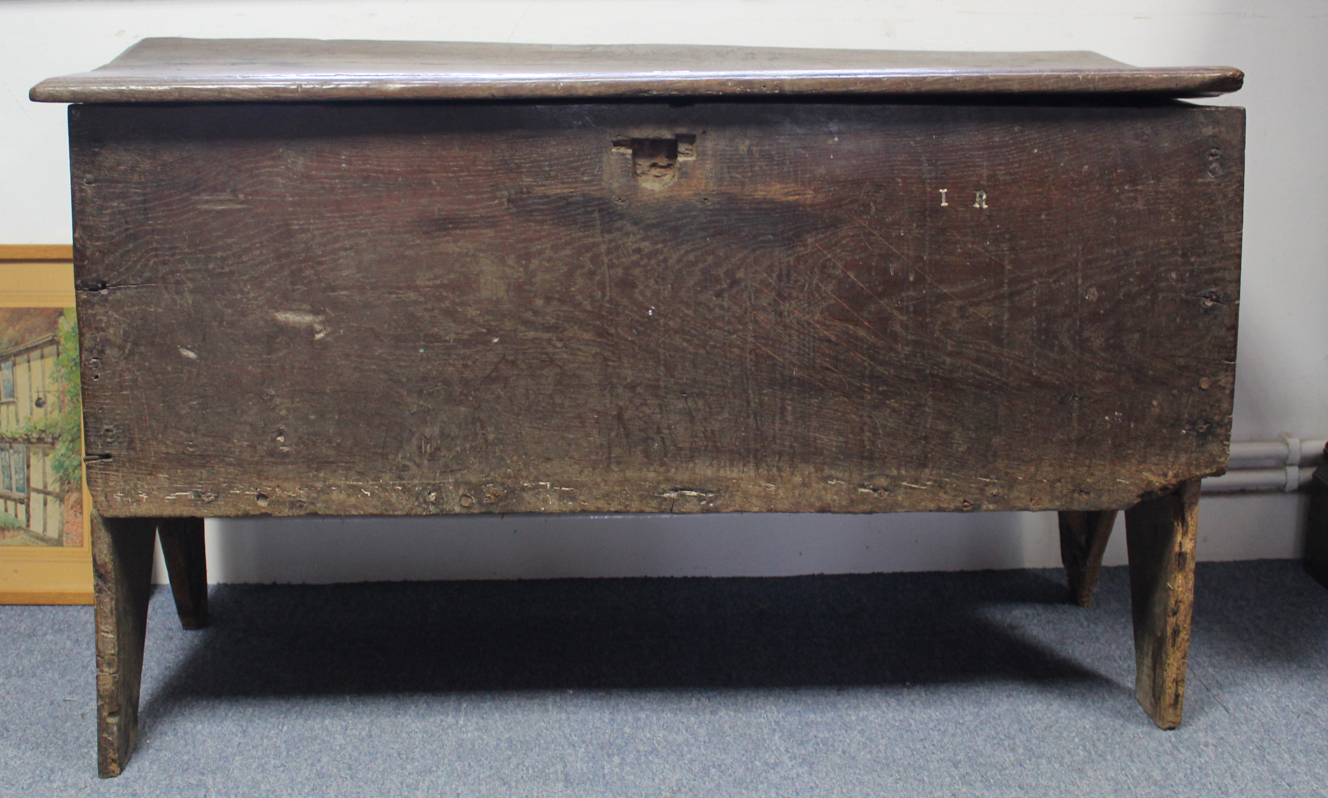 An early 18th century elm coffer of six-plank construction, the lift-lid with moulded edge; 43” wide