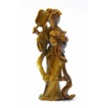 A CHINESE CARVED “TIGER’S-EYE” STANDING FEMALE FIGURE wearing long flowing robes, holding a fan in