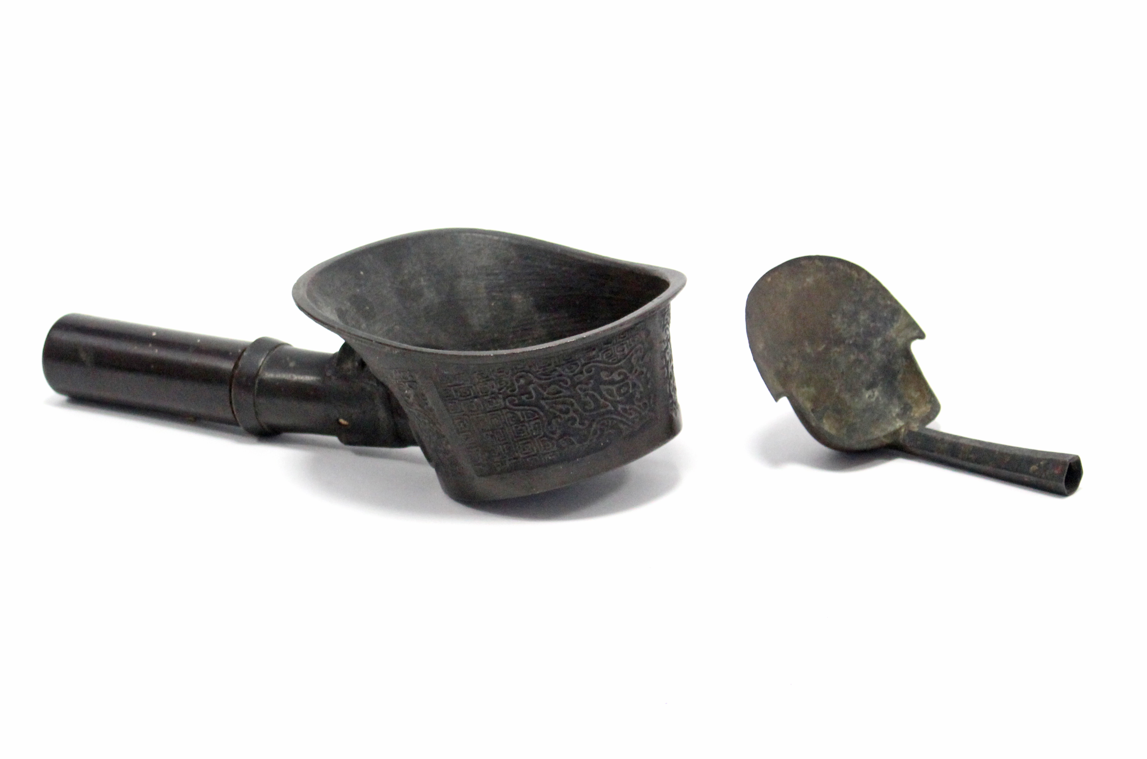 A Chinese archaistic bronze ceremonial ladle with relief decoration on a key-pattern ground, plain