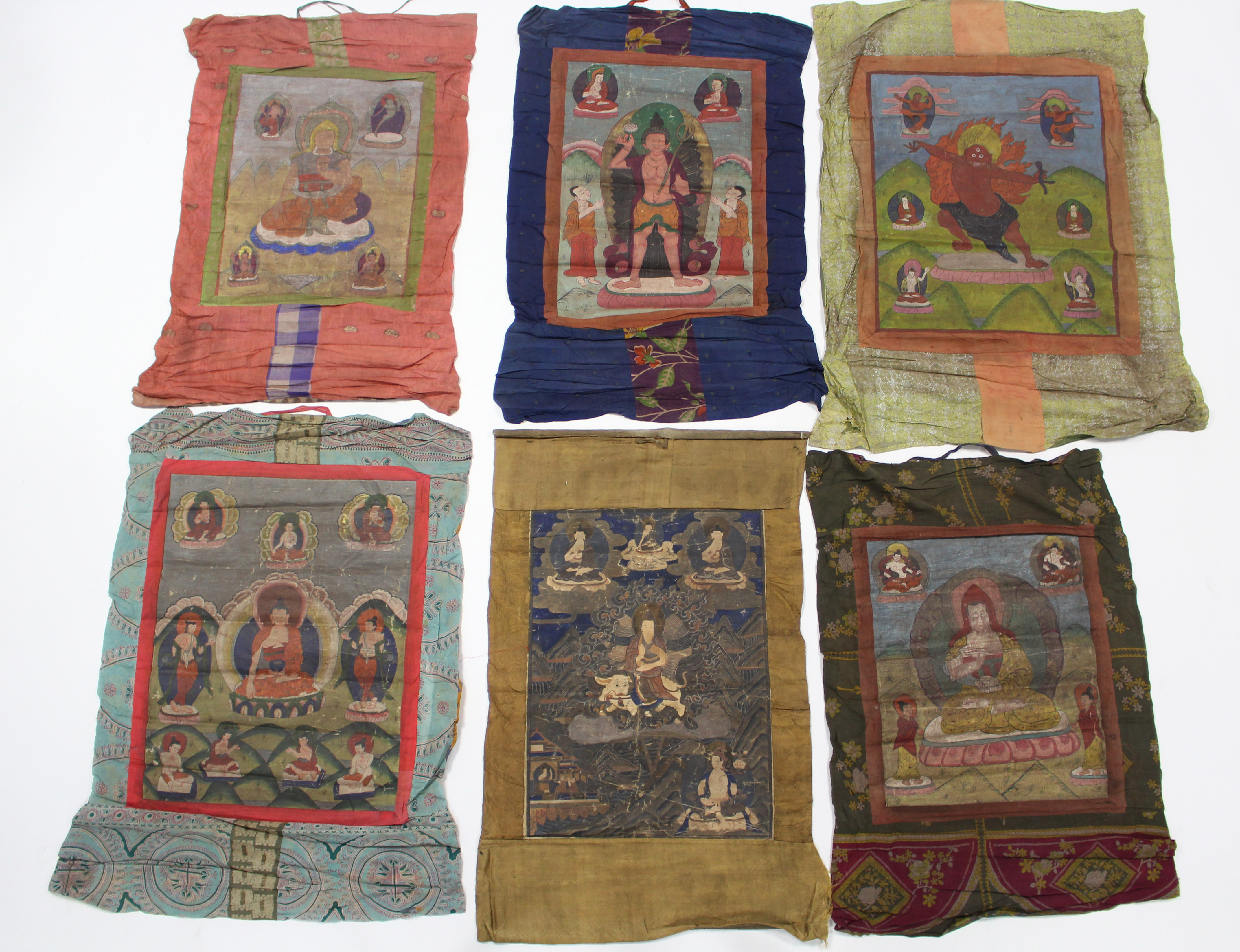 A group of six various Tibetan Thankas; the largest: 23” x 19”.