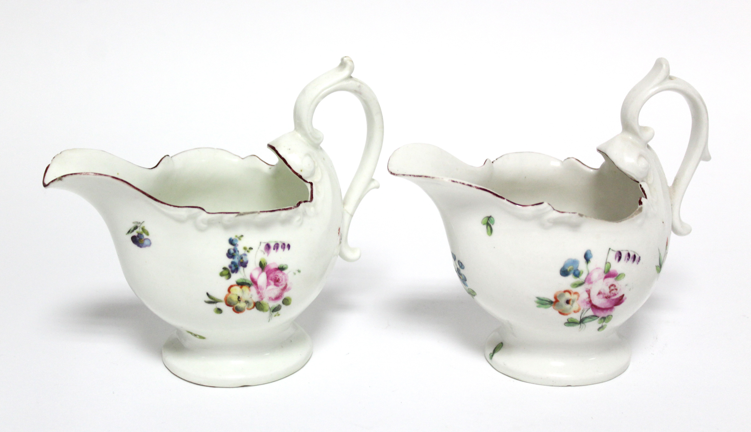 A pair of 18th century Derby porcelain sauce boats, each of moulded shell form with scroll