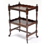 A Victorian mahogany two-tier whatnot with beaded edge & shaped tray-top, on slender turned supports