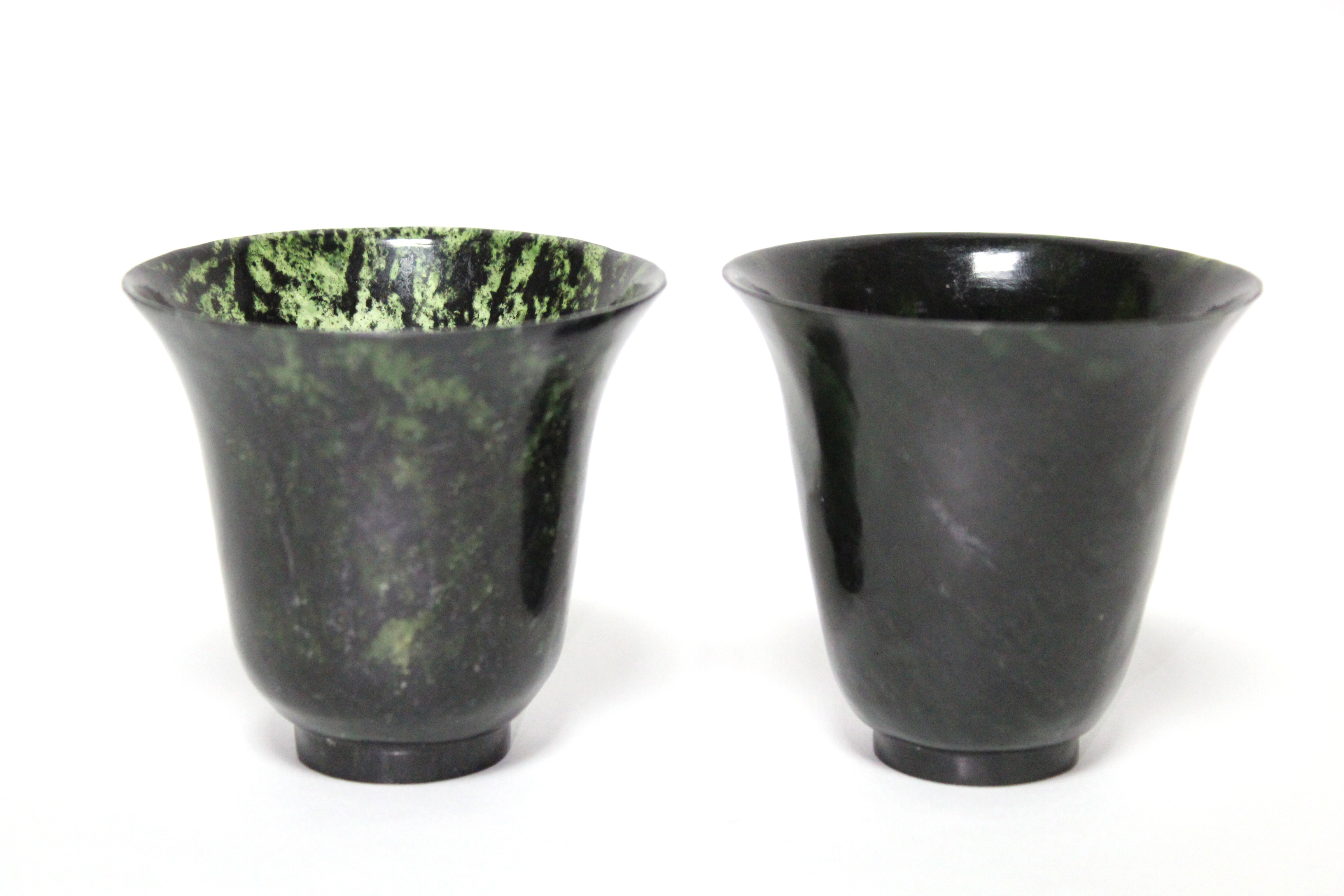 A pair of spinach-green jade beakers with flared rims, each on narrow ring foot; 2¾” high x 3”