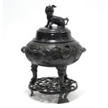 A Chinese bronze large circular tripod censer, the domed cover with Qilin finial & pierced trigrams,