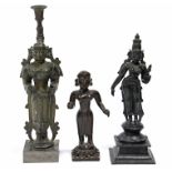 Two Indian bronze standing deities, 12½” & 8¾” high; & a similar candlestick figure, 15”.