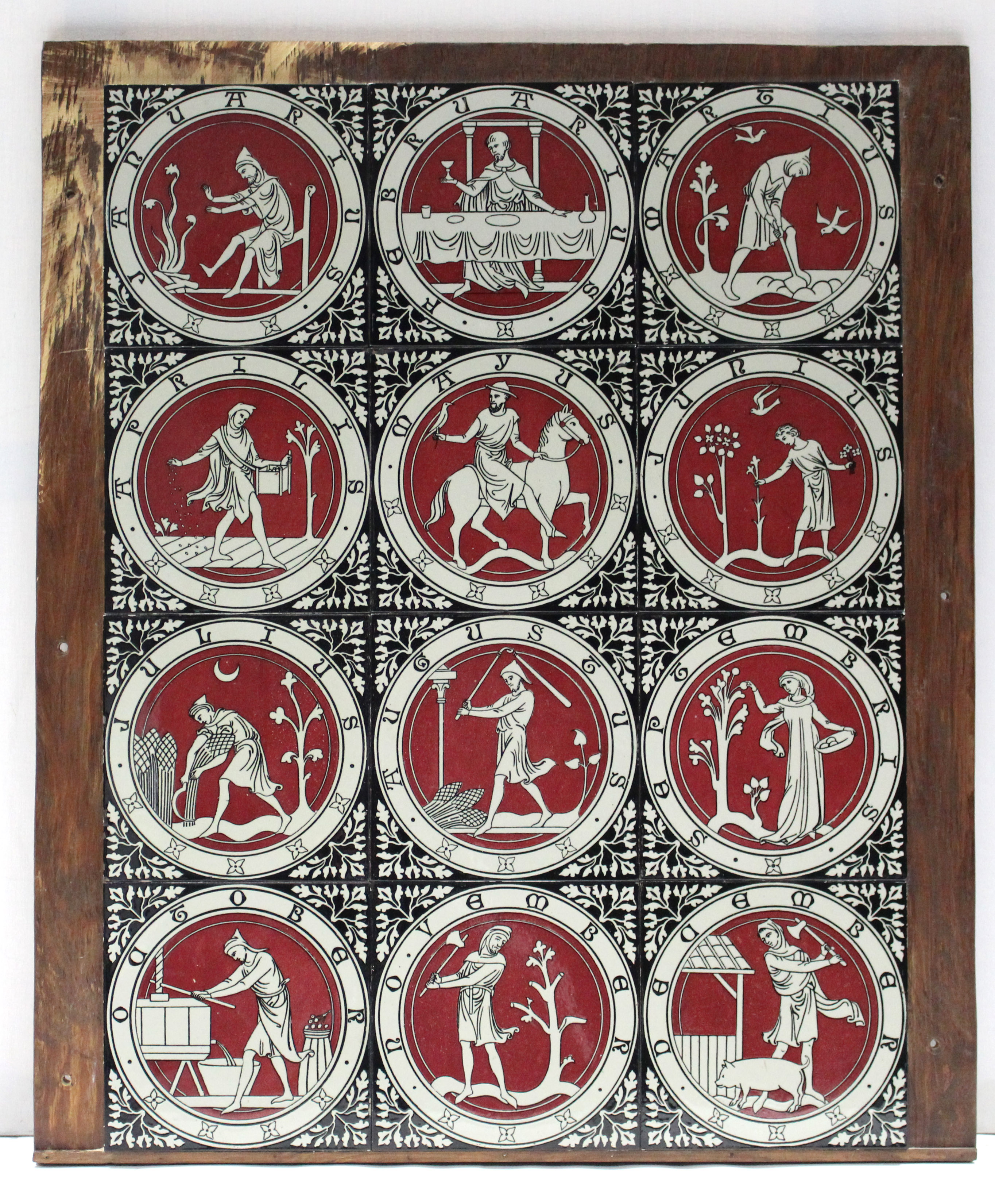 A SET OF TWELVE VICTORIAN POTTERY TILES, representing the months of the year, each depicting a