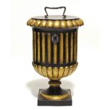 A REGENCY EBONISED & PARCEL-GILT URN SHAPED TEA CADDY, with fluted body, the hinged lid with