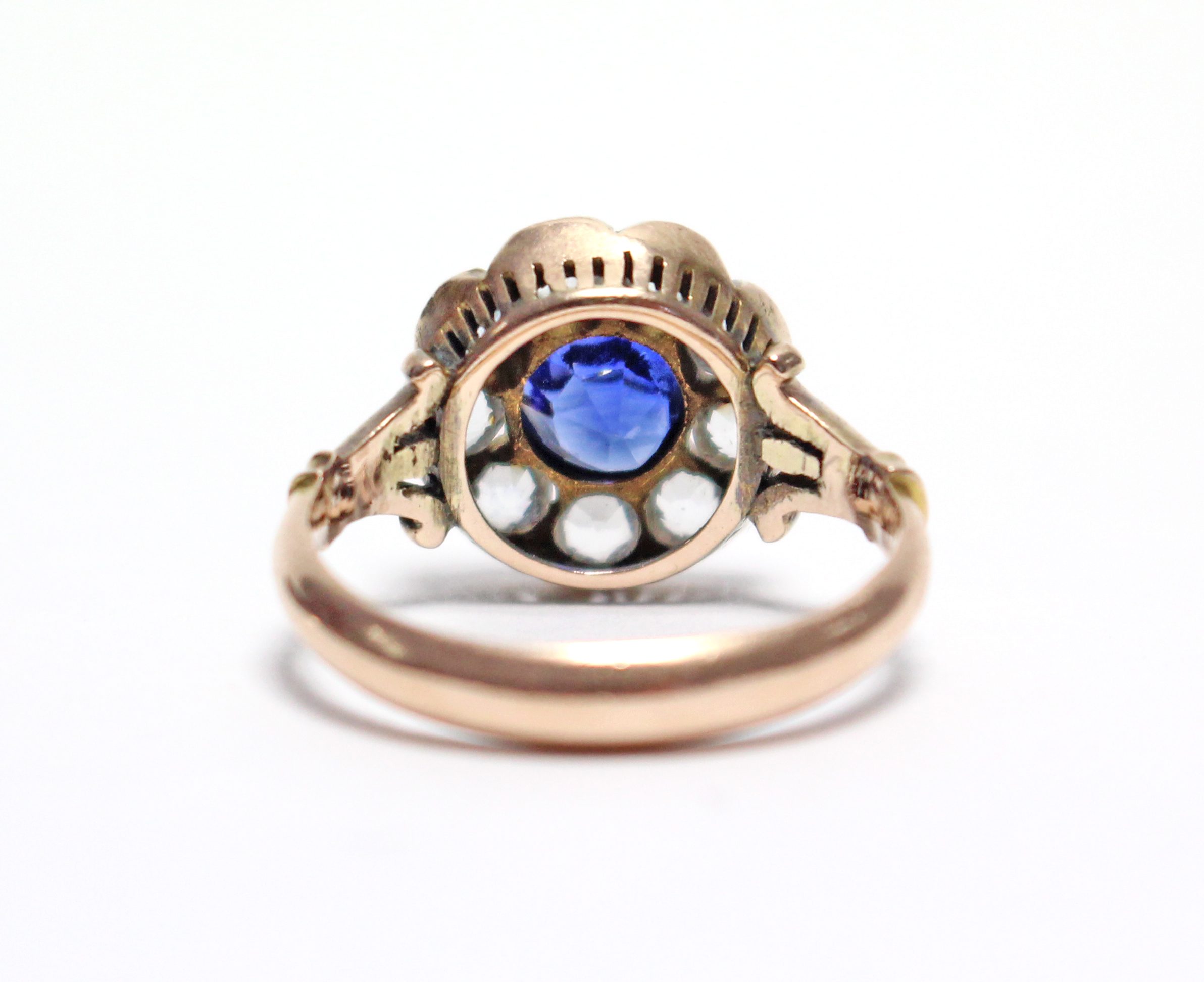 A late Victorian gold ring, millegrain-set with a round sapphire of approx. 0.75 carat within a - Image 3 of 3