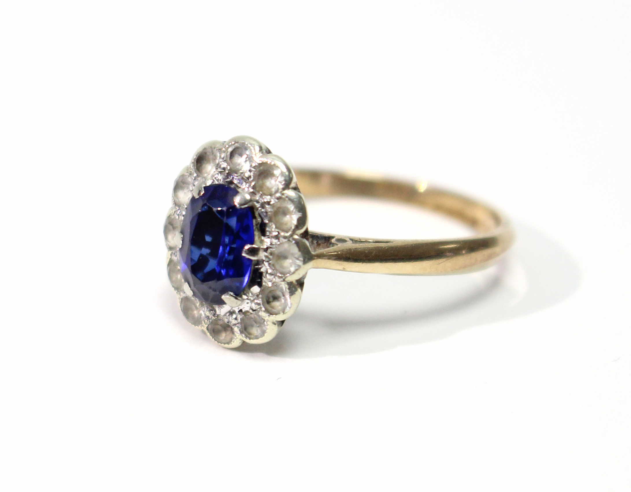 A 9ct. gold ring set oval synthetic sapphire within a border of small diamonds. - Image 2 of 5