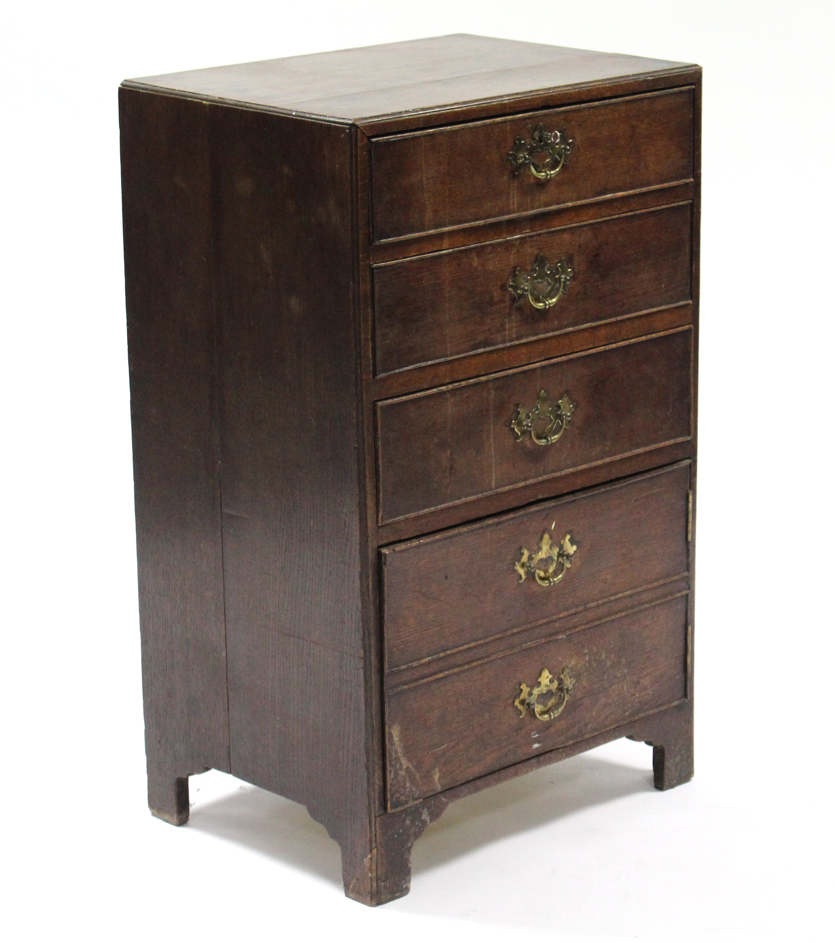 An 18th century style narrow oak chest fitted three drawers with brass swing handles above a