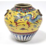 A Chinese crackle-glazed pottery squat round vase painted in under-glaze blue with a dragon
