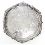 An Edwardian silver hexafoil salver with beaded, husk, & leaf-scroll raised border, the centre