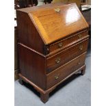 An 18th century elm bureau, in two sections, the upper part fitted frieze drawer below the sloping