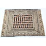 A needlework Sumac Kelim rug of cream ground with central panel of lozenges with multiple