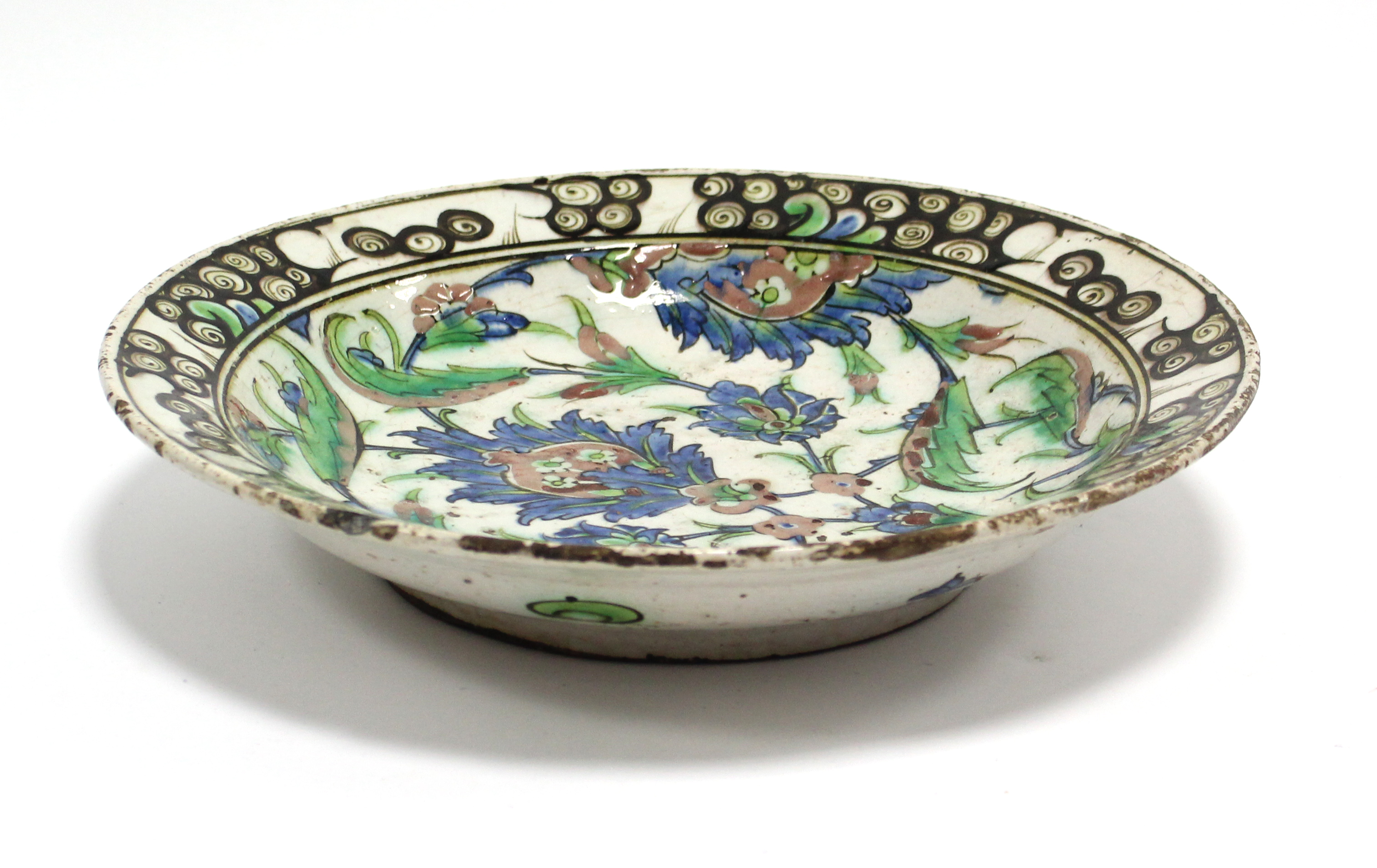 A 17th century IZNIK POTTERY SHALLOW DISH with polychrome painted stylised floral decoration - Image 3 of 6