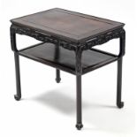 A Chinese hardwood two-tier occasional table, with rectangular top, carved frieze, on rounded legs