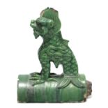 A Chinese tileworks green-glazed pottery ridge tile finial in the form of a seated Quilin; 13”