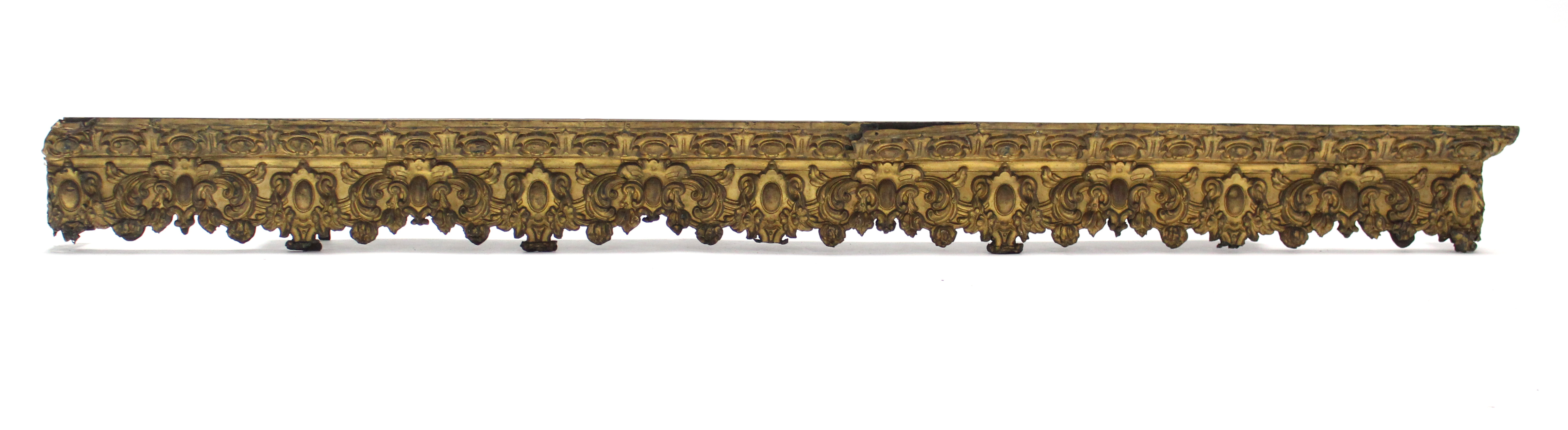 A 19th century curtain pelmet, with embossed metal foliate decoration; 75” wide x 7” high.