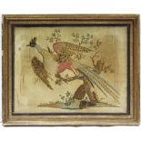 A Regency silk needlework panel depicting a pheasant in flight against trees on a grassy mound;