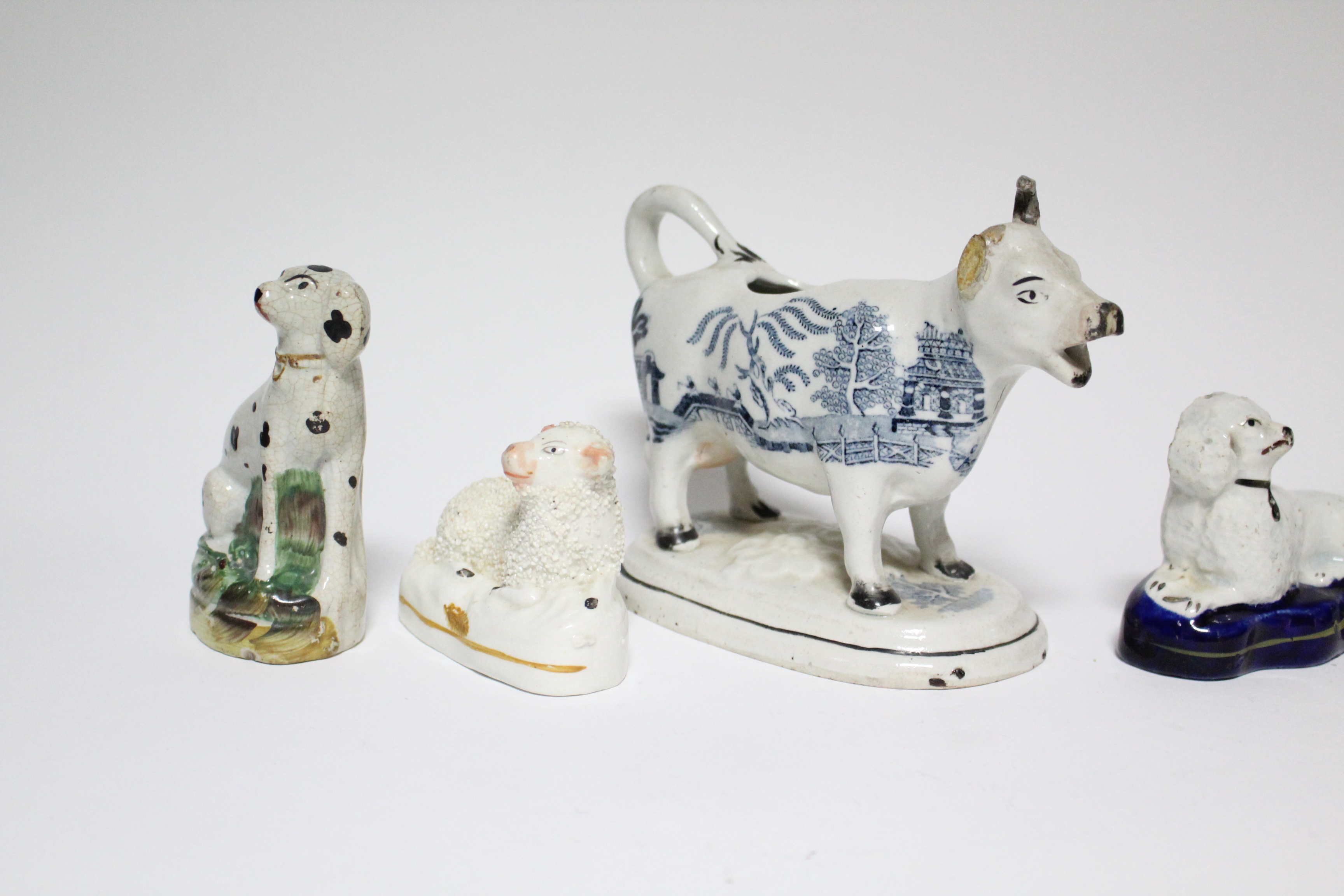 Three small Victorian Staffordshire pottery models of seated dogs, the largest 4” high; a ditto - Image 3 of 5