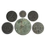 Six Chinese archaistic bronze small circular mirrors, five with raised decoration, the sixth