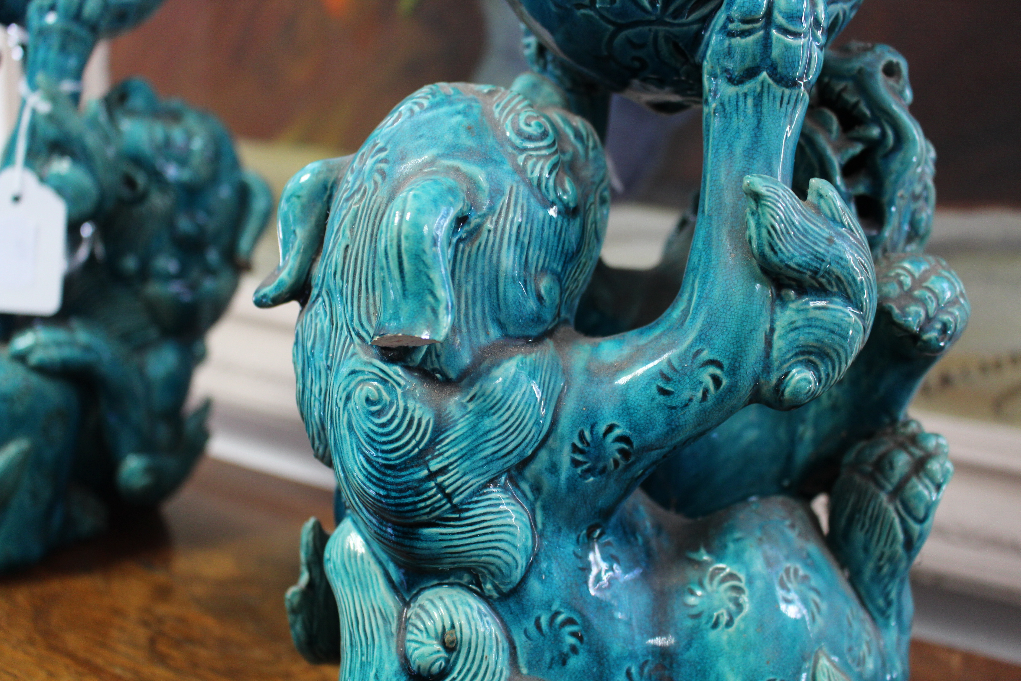 A pair of 19th century Chinese turquoise-glazed groups, each of two Kylin fighting over a brocaded - Image 5 of 9