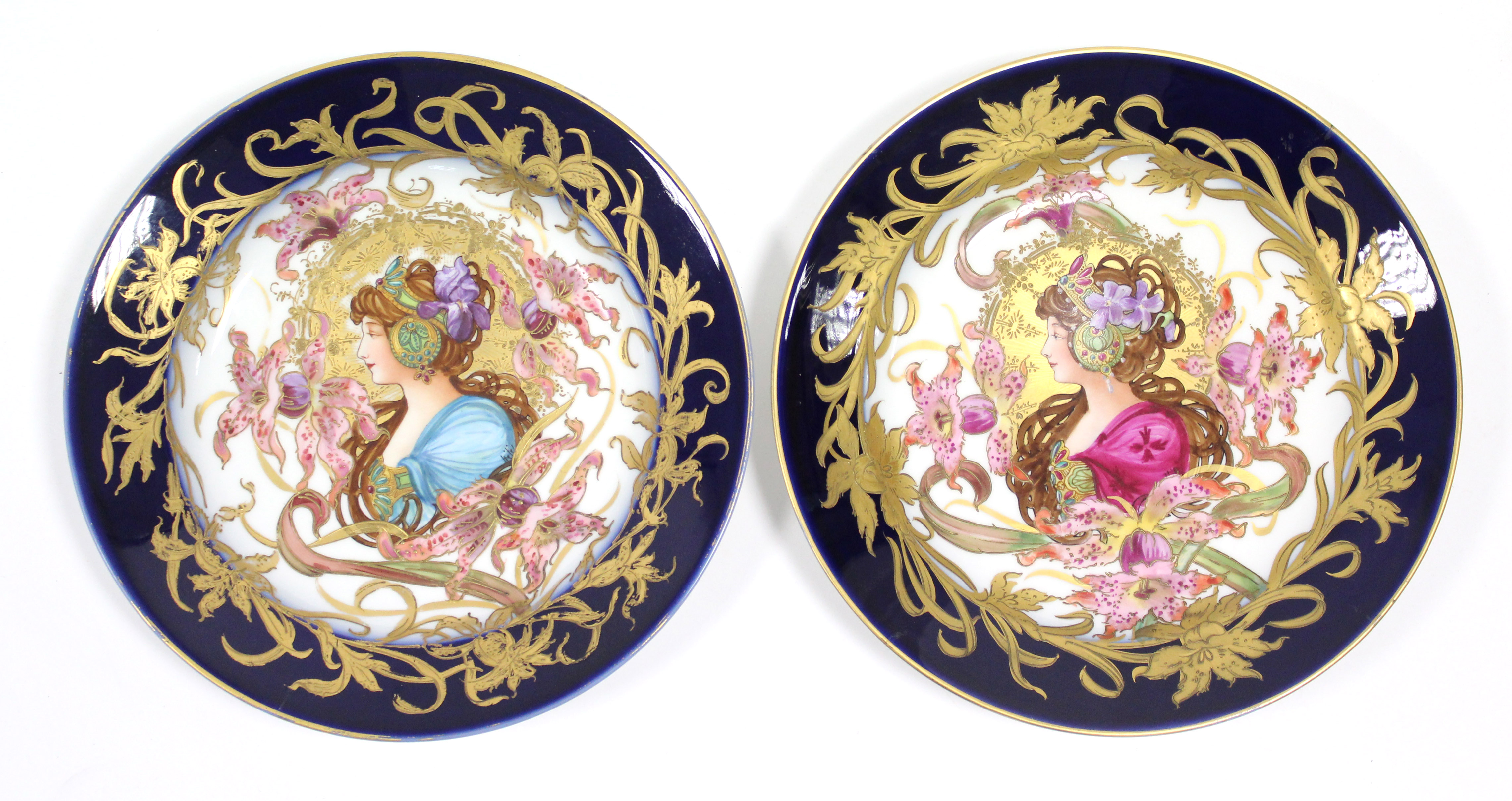 A pair of continental porcelain shallow dishes with Art Nouveau decoration of female busts