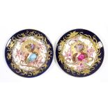 A pair of continental porcelain shallow dishes with Art Nouveau decoration of female busts