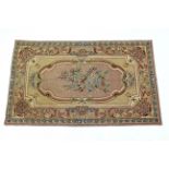 A Kashmiri hook-stitch rug of Aubusson design, cream & peach ground, with central reserve of flowers