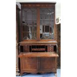 An early 19th century mahogany secretaire bookcase with moulded cornice, fitted six adjustable