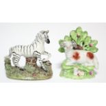 A Victorian Staffordshire pottery model of a Zebra, its left fore-leg raised, on mound base, 4¾”