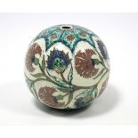 An Iznik-style pottery spherical pendant with painted floral decoration on a cream ground; 8” diam.