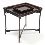 A Chinese hardwood rectangular tray-top table with pierced gallery & frieze, on fold-away scroll