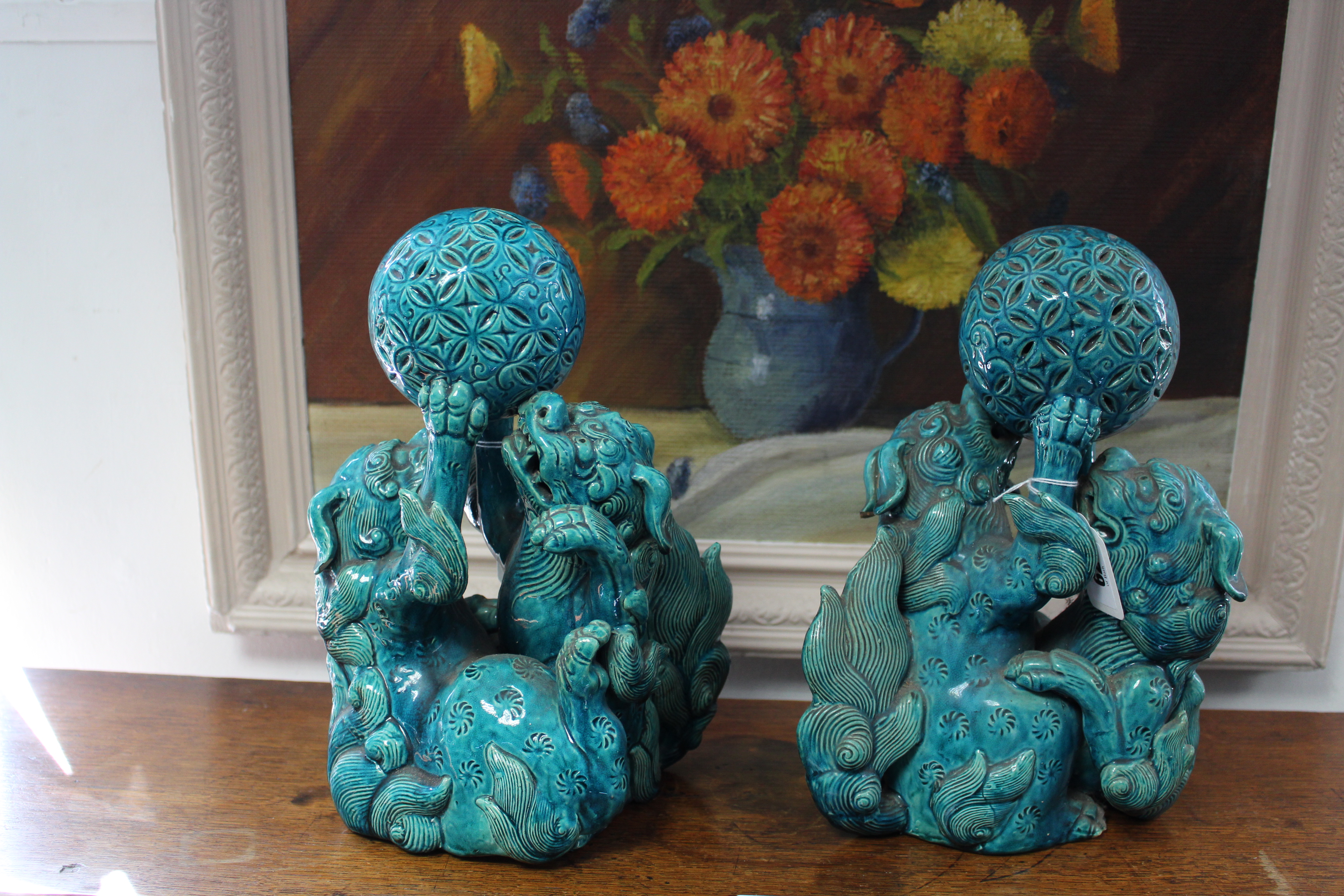 A pair of 19th century Chinese turquoise-glazed groups, each of two Kylin fighting over a brocaded - Image 4 of 9